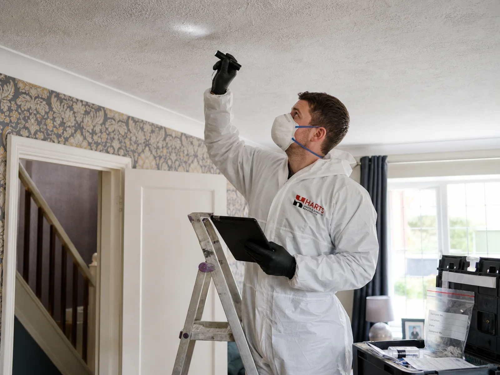 Professional building surveyors in hi-vis vests inspecting a property in Essex