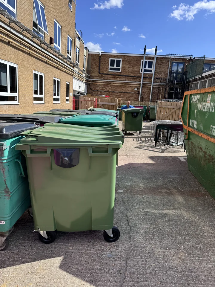 Bins and loose items in the courtyard before clearance
