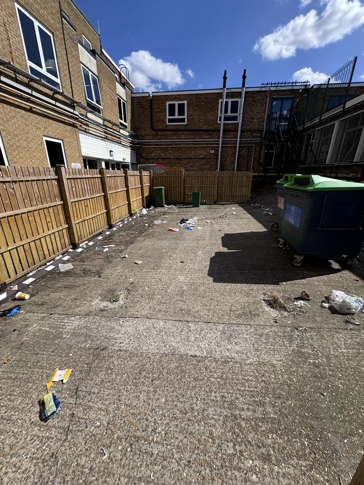 Courtyard during clearance with loose debris still visible