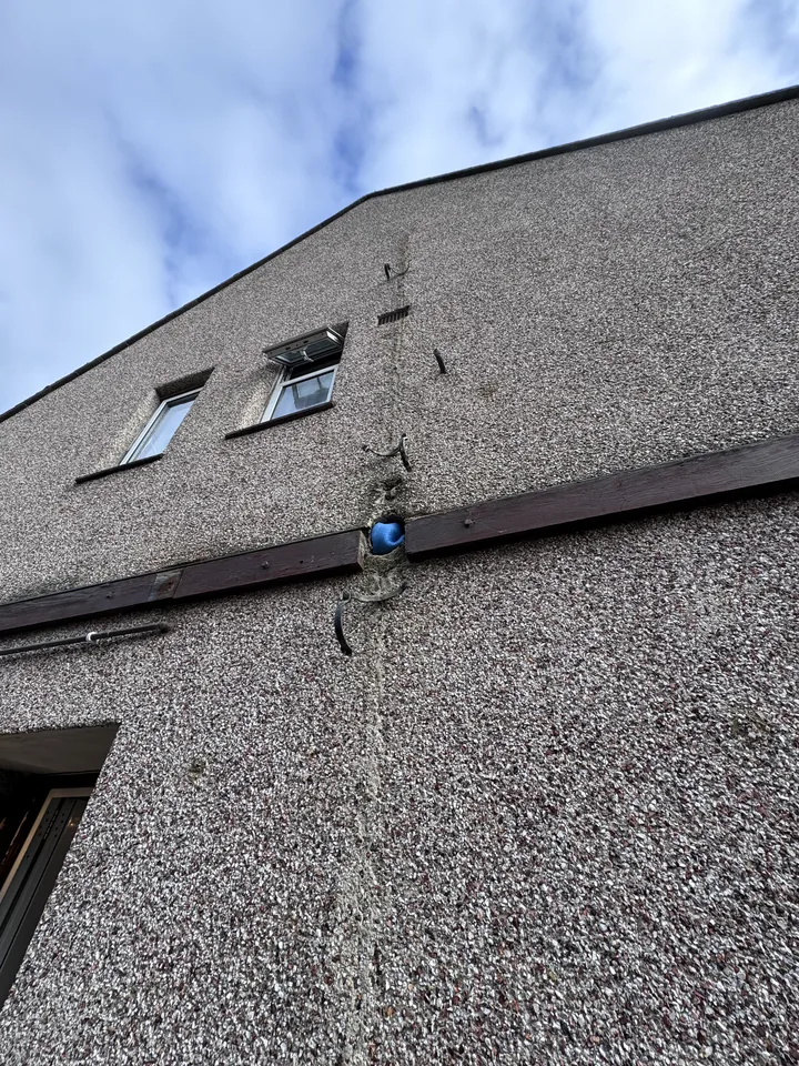 Building wall after the downpipe was removed