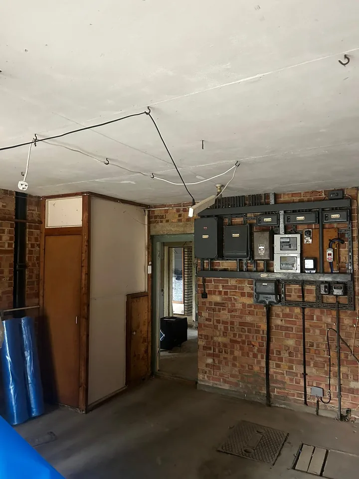 Ceiling and brick walls viewed from the opposite side of a room