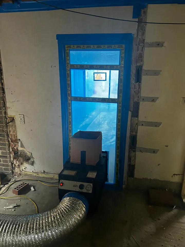 Sealed doorway with ventilation equipment during interior work