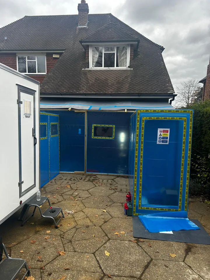 External blue enclosure beside a house