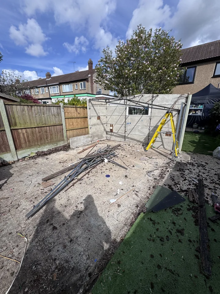 Partially dismantled garage with remaining framework