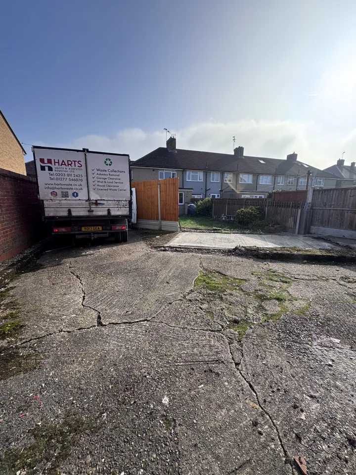 Second view of the cleared garage footprint with the work vehicle