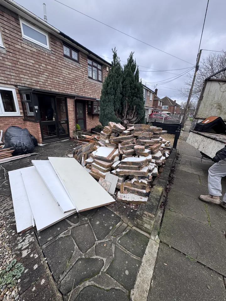 Piled timber and garden waste before clearance
