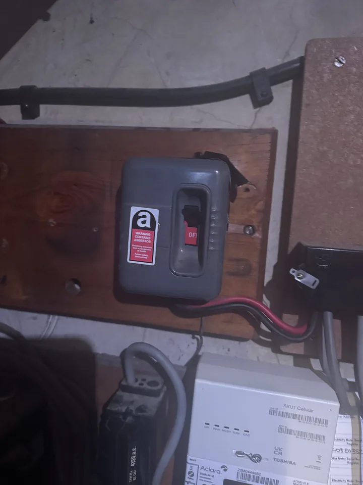 Close view of a warning label on older electrical equipment
