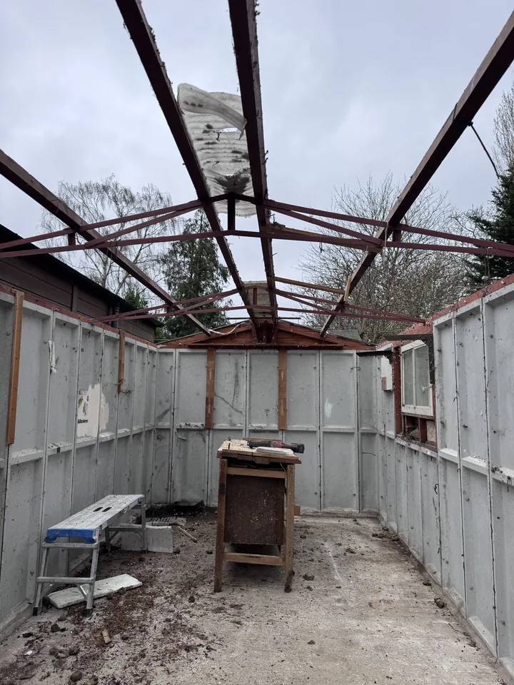 Garage framework after roof sheet removal viewed from the other end