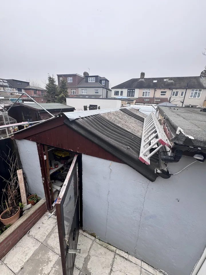 Corrugated outbuilding roof before sheet removal
