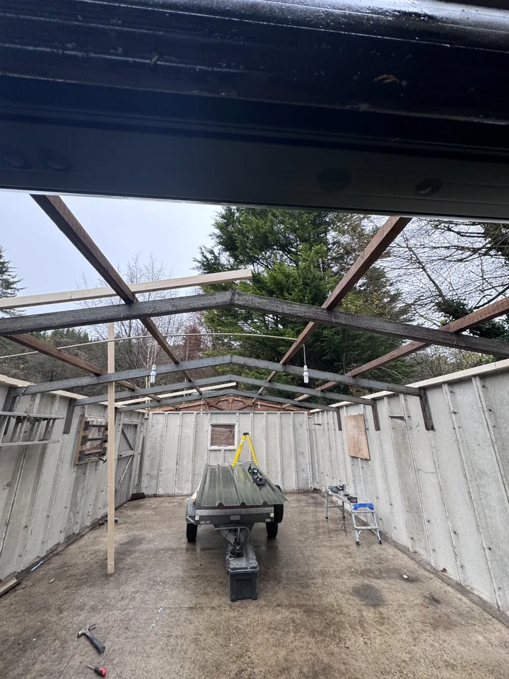 Garage interior with roof sheets removed and framework exposed