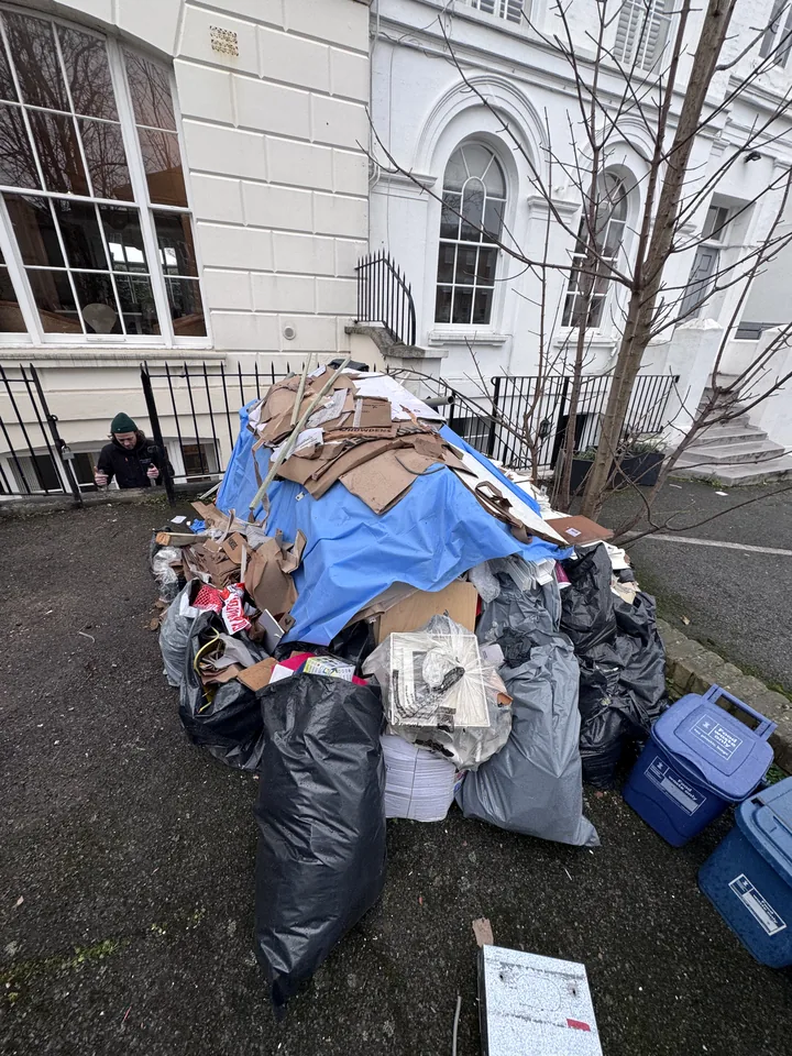 Pile of mixed rubbish outside a building before collection